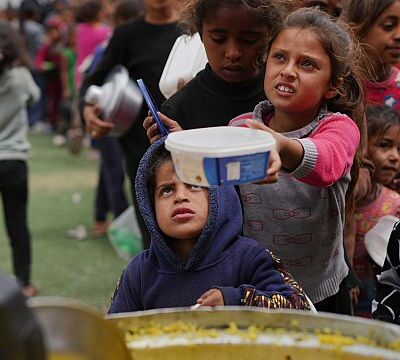Palestinians lined up for hours for food by a charity kitchen in central Gaza.